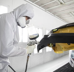 Collision Center Technician Painting a Vehicle | Toyota of Kingsport in Kingsport TN